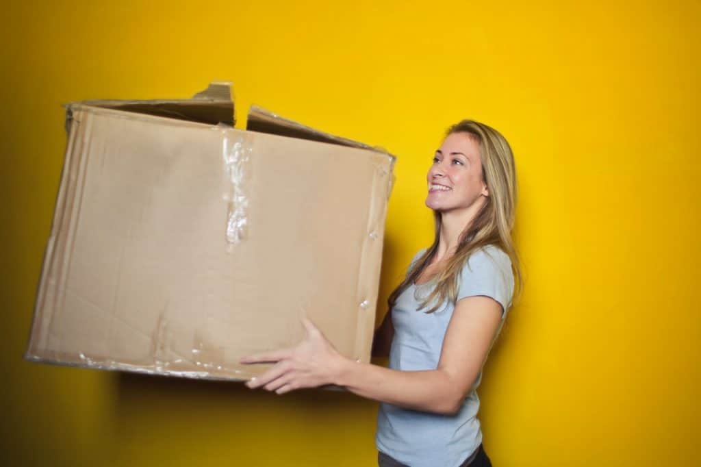 Blonde women holding a cardboard box