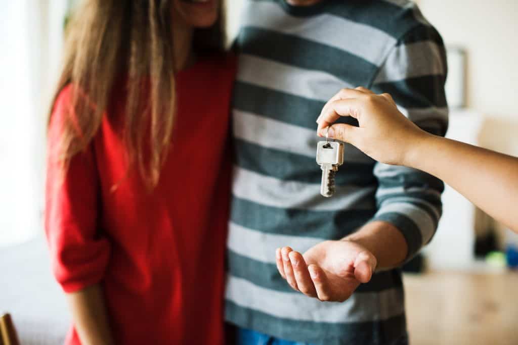 Couple receiving a key of a new home