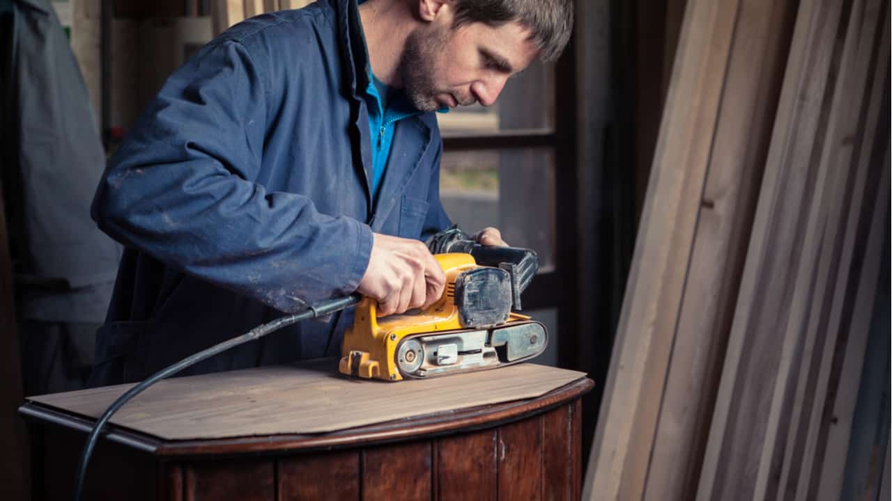 Carpenter using a belt sander