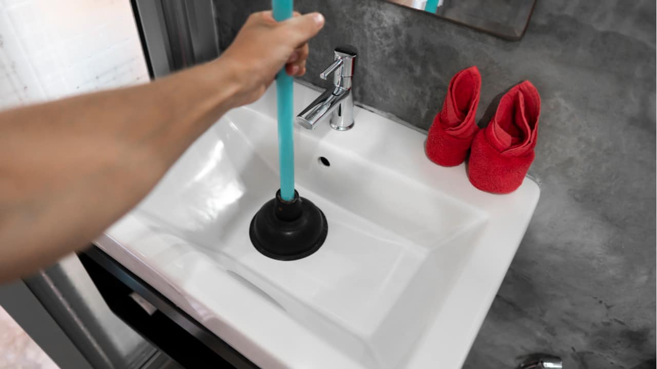 Man holds a plunger