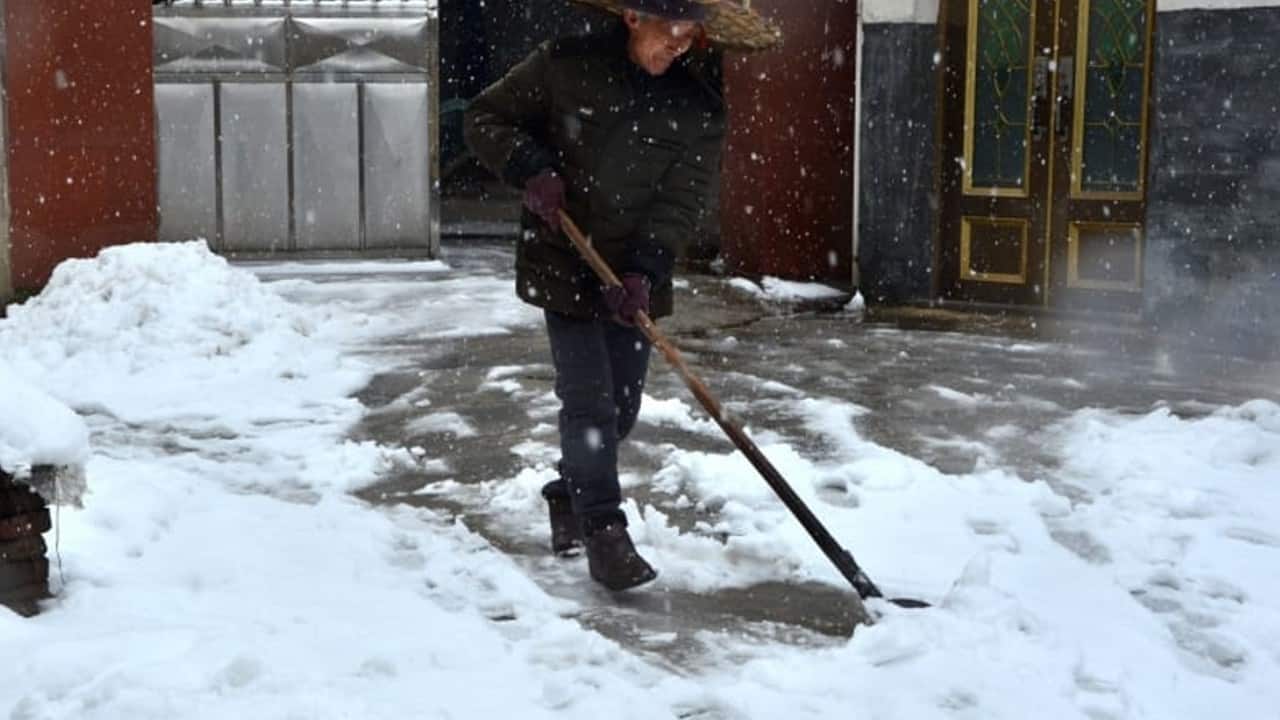 Man using a snow rake