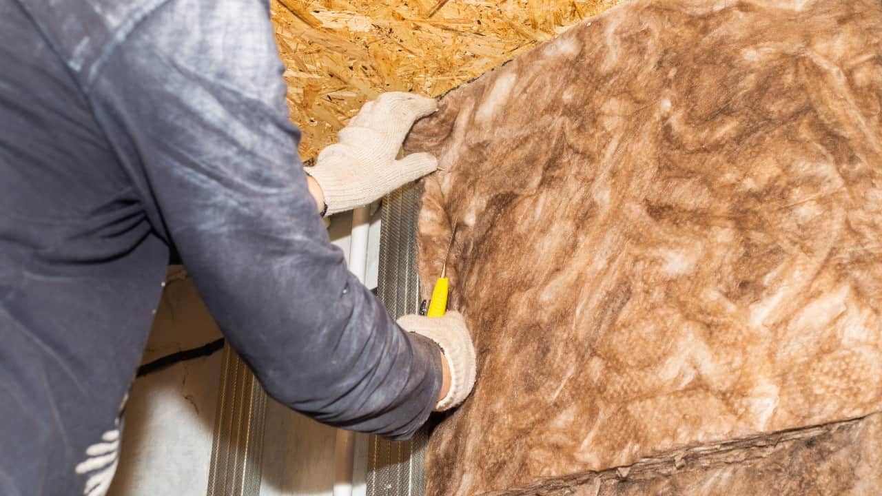 Man cuts insulation