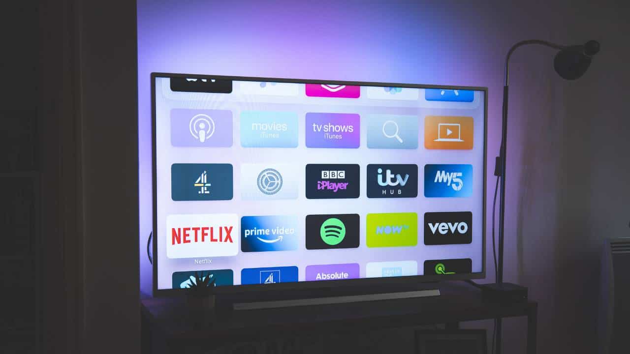 A smart TV with purple lighting in the background
